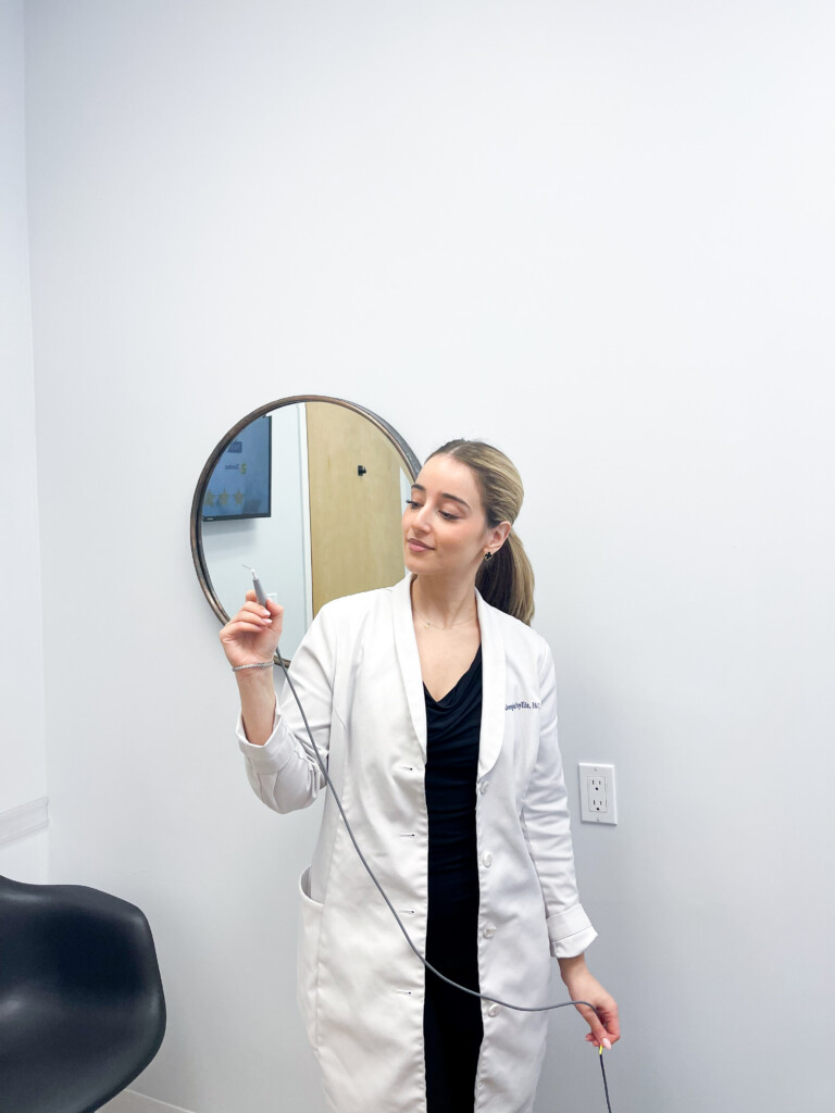 Despina, physician assistant, reviewing skin during a consultation at Simply Dermatology