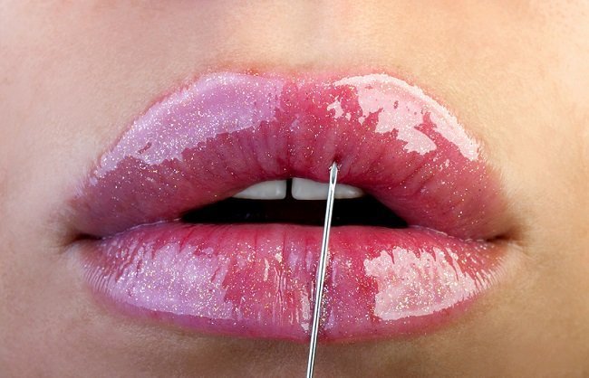 closeup of lipstick being applied to lips