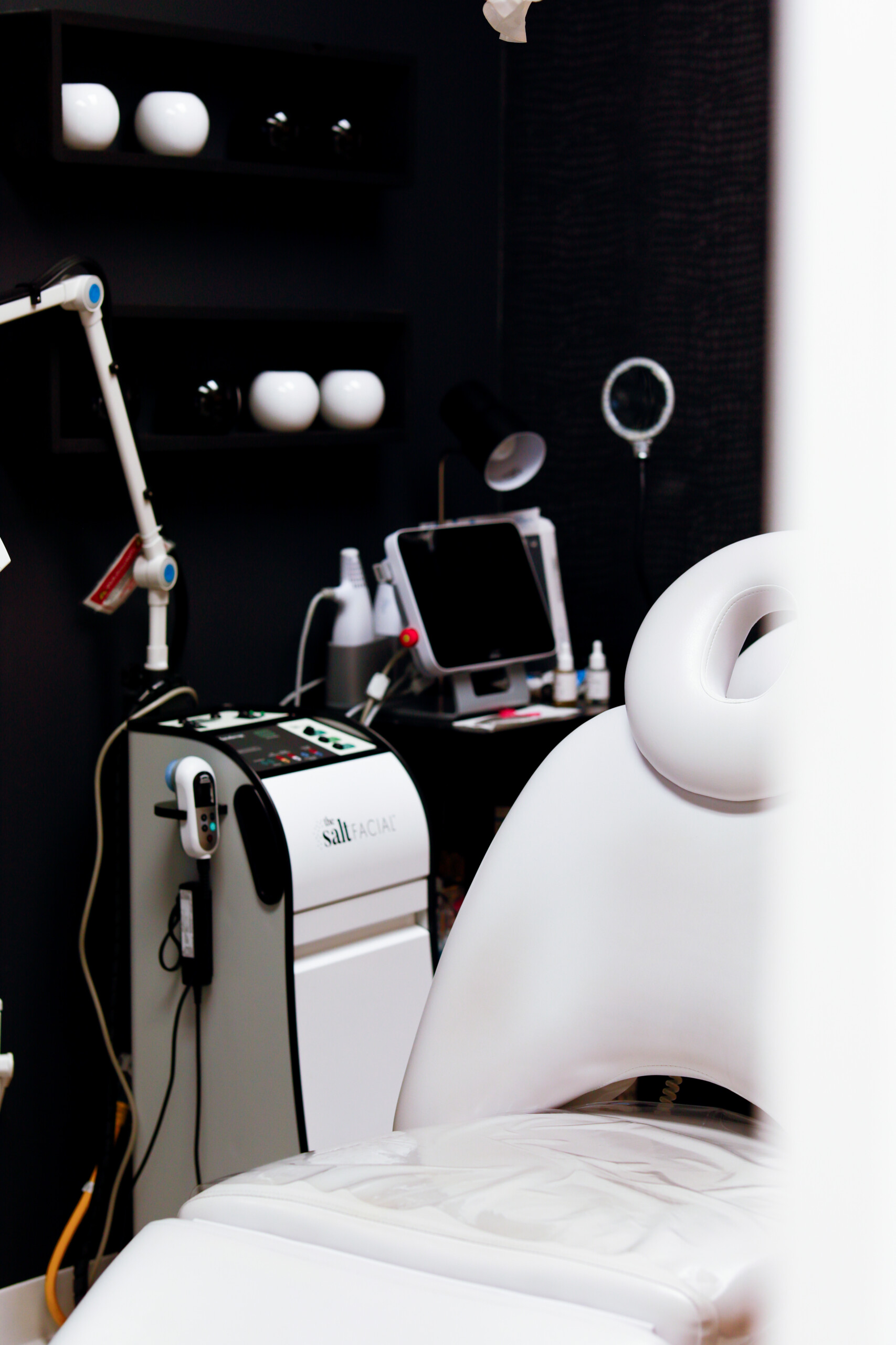Modern facial treatment room at Simply Dermatology featuring The Salt Facial device, treatment chair, and professional skincare equipment.