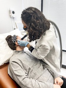 Dr. Papantoniou using the Q-Switch laser on a patients face