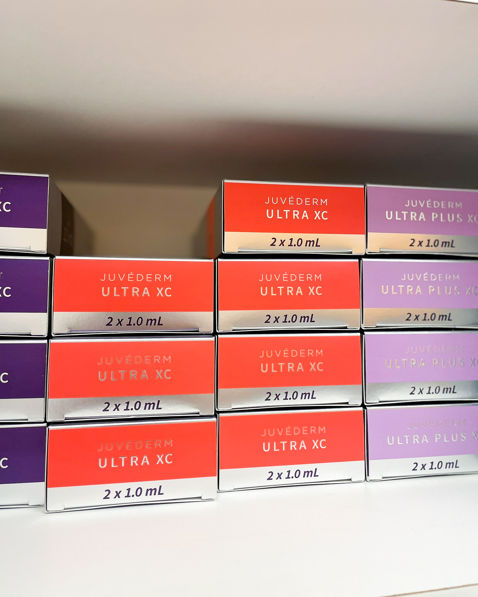 Juvederm Ultra XC and Juvederm Ultra Plus XC dermal filler boxes used for natural-looking fillers at Simply Dermatology.