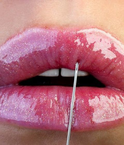 closeup of lipstick being applied to lips