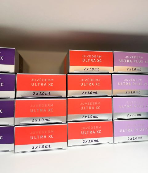 Juvederm Ultra XC and Juvederm Ultra Plus XC dermal filler boxes used for natural-looking fillers at Simply Dermatology.
